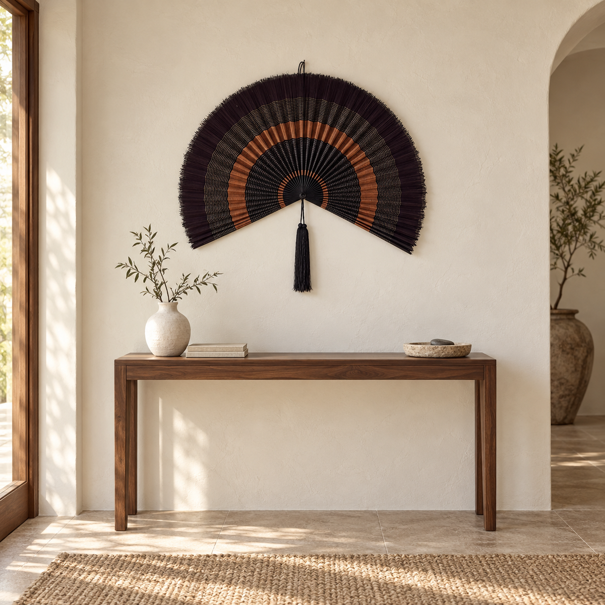 Black and copper woven bamboo wall fan decor above a walnut entryway console