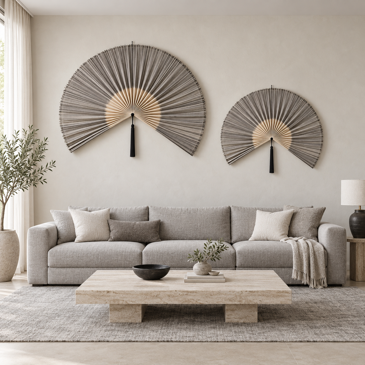 Two gradient gray bamboo wall fans displayed above a neutral living room sofa