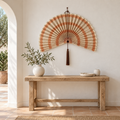 Terracotta orange striped wall fan above a Mediterranean entryway console