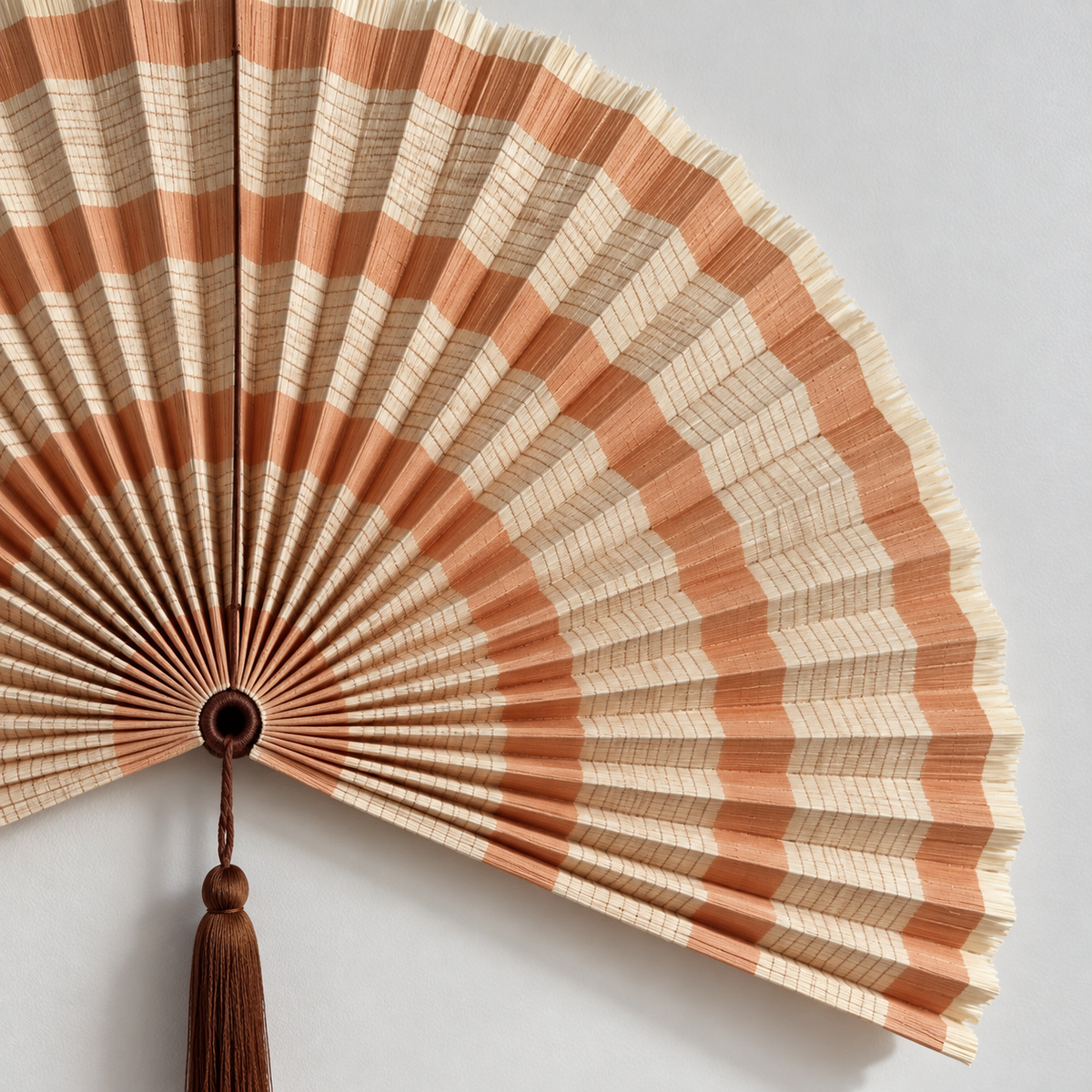 Close-up of orange and cream woven stripes and fine pleated texture