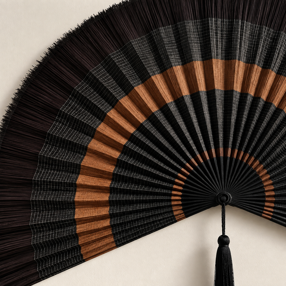 Close-up of layered black weaving and copper-brown bands