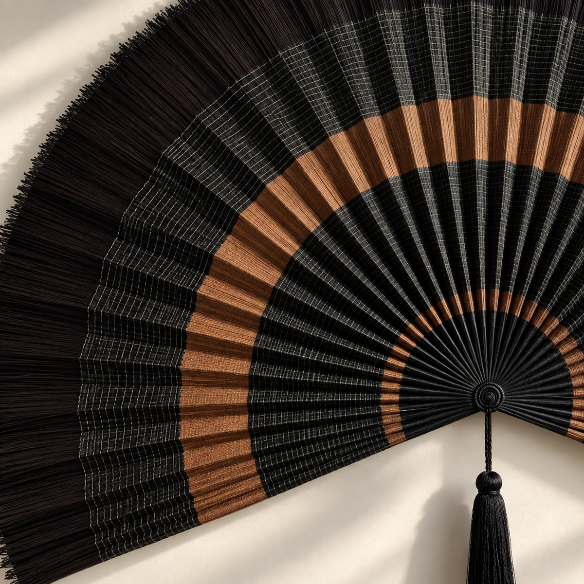 Close-up of layered black weaving and copper-brown bands
