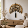 Handcrafted beige brown bamboo folding fan wall decor with dark green tassel, shown open and closed.